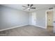 A room with a ceiling fan, gray walls, wood-look flooring, and a white interior door at 11012 E Elton Ave, Mesa, AZ 85208