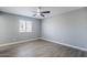 Well-lit bedroom with gray walls, a ceiling fan, and wood-look flooring at 11012 E Elton Ave, Mesa, AZ 85208