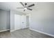 Bedroom with gray walls, wood-look flooring, closet doors, and a ceiling fan at 11012 E Elton Ave, Mesa, AZ 85208