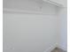 A clean walk-in closet space with light gray walls and white trim at 11012 E Elton Ave, Mesa, AZ 85208