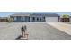Inviting single-story home with solar panels, gravel landscaping, and a well-kept front lawn at 11012 E Elton Ave, Mesa, AZ 85208