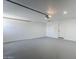 Bright, spacious garage with a gray epoxy floor, offering ample storage and parking space at 11012 E Elton Ave, Mesa, AZ 85208
