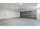 Spacious garage featuring a modern gray door and ample room for parking and storage at 11012 E Elton Ave, Mesa, AZ 85208