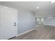 Hallway features grey walls, white doors and trim, and wood-look vinyl plank flooring at 11012 E Elton Ave, Mesa, AZ 85208
