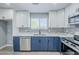 Stylish kitchen with stainless steel appliances, modern countertops, and white and blue cabinetry at 11012 E Elton Ave, Mesa, AZ 85208