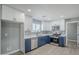 Updated kitchen with white upper cabinets, blue lower cabinets, and stainless steel appliances at 11012 E Elton Ave, Mesa, AZ 85208