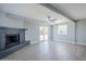 Bright living room with laminate floors, stylish gray fireplace, and sliding doors to the backyard at 11012 E Elton Ave, Mesa, AZ 85208