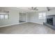 Spacious living room with light grey walls, wood-look floors and a painted brick fireplace at 11012 E Elton Ave, Mesa, AZ 85208