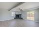 Bright living room features a painted brick fireplace, ceiling fan and access to the backyard at 11012 E Elton Ave, Mesa, AZ 85208