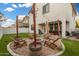 Backyard featuring a fire pit, seating, outdoor lighting, and a spa at 11541 E Corbin Ave, Mesa, AZ 85212