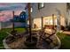Backyard featuring fire pit, string lights, and covered patio at 11541 E Corbin Ave, Mesa, AZ 85212
