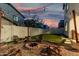 Backyard with fire pit, string lights, and green artificial turf at 11541 E Corbin Ave, Mesa, AZ 85212