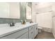 Bathroom featuring a double vanity, modern mirrors, and tiled wall accents above a tiled floor at 11541 E Corbin Ave, Mesa, AZ 85212