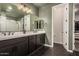 Modern bathroom features dual sinks, dark cabinets, and a large mirror at 11541 E Corbin Ave, Mesa, AZ 85212