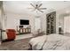 Bright and open bedroom with unique seating, a large TV, and an attached bath at 11541 E Corbin Ave, Mesa, AZ 85212