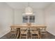 Bright dining room features wood table, six chairs, and a stylish overhead light fixture at 11541 E Corbin Ave, Mesa, AZ 85212