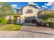 Daytime view of a charming two-story home showcasing a well-kept lawn and paved driveway with a black Toyota truck at 11541 E Corbin Ave, Mesa, AZ 85212