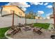 Cozy fire pit area with wood chairs and charming string lights at 11541 E Corbin Ave, Mesa, AZ 85212