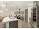 Well-lit kitchen features white countertops, green cabinets, stainless steel appliances, and wood floors at 11541 E Corbin Ave, Mesa, AZ 85212