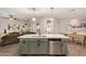 Open-concept kitchen with island, stainless appliances, and hardwood floors connected to living room at 11541 E Corbin Ave, Mesa, AZ 85212