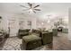 Comfortable living room with a ceiling fan, carpet, and a spacious green couch at 11541 E Corbin Ave, Mesa, AZ 85212