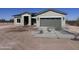 Charming single story home with a two car garage, desert landscaping, and a concrete driveway at 11650 N Abel Pl, Florence, AZ 85132