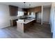 Bright kitchen features an island, wood cabinets, granite countertops, stainless steel appliances, and tile floors at 11650 N Abel Pl, Florence, AZ 85132