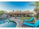 Spacious backyard featuring a swimming pool, covered patio, lounge chairs, and well-maintained landscaping at 11822 S Coconino St, Phoenix, AZ 85044