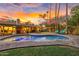 Beautiful backyard with outdoor seating, heated pool, and gorgeous sunset at 11822 S Coconino St, Phoenix, AZ 85044