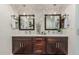 Modern bathroom with dual sinks, dark wood cabinets, decorative mirrors, and stylish lighting at 11822 S Coconino St, Phoenix, AZ 85044