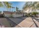 Charming home features a wide driveway with brick accents and a well-manicured yard with mature trees at 11822 S Coconino St, Phoenix, AZ 85044