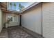 Welcoming front entrance with brick paving and a small window provides natural light for this single-story home at 11822 S Coconino St, Phoenix, AZ 85044