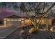 Inviting home with brick walkway, desert landscaping, well-lit exterior, and a two-car garage at 11822 S Coconino St, Phoenix, AZ 85044