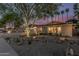 Beautiful single-story home featuring a desert landscaped front yard, a two-car garage, and a sunset sky at 11822 S Coconino St, Phoenix, AZ 85044