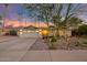 Charming single-story home with a well-manicured desert landscape and a welcoming entrance at twilight at 11822 S Coconino St, Phoenix, AZ 85044