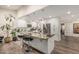 Bright, modern kitchen features a large island with bar stools, stainless steel appliances, and stylish pendant lighting at 11822 S Coconino St, Phoenix, AZ 85044