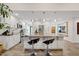 Bright kitchen featuring a large island with bar stools and pendant lighting, ample counterspace at 11822 S Coconino St, Phoenix, AZ 85044