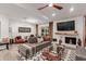 Stylish living room with a brick fireplace, sleek furniture, and an eye-catching ceiling fan at 11822 S Coconino St, Phoenix, AZ 85044