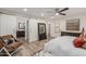 Bright bedroom features a sliding barn door to ensuite bathroom with a comfy chair and dresser at 11822 S Coconino St, Phoenix, AZ 85044