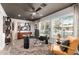 Office space with glass-top desk, ceiling fan, modern art, and bright natural light at 11822 S Coconino St, Phoenix, AZ 85044