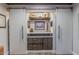 Office built-ins with open shelves and white sliding barn doors at 11822 S Coconino St, Phoenix, AZ 85044