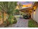 Expansive patio with dining and lounge areas overlooking a lush backyard with mature trees and landscaping at 11822 S Coconino St, Phoenix, AZ 85044