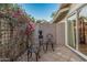 Cozy patio with a quaint seating area and vibrant floral accents, ideal for relaxation and entertaining at 11822 S Coconino St, Phoenix, AZ 85044
