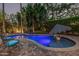 Backyard pool with lush landscaping and a serene atmosphere for relaxing evenings at 11822 S Coconino St, Phoenix, AZ 85044