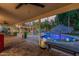Backyard with covered patio, string lights, poolside lounge chairs and a refreshing pool, perfect for entertaining at 11822 S Coconino St, Phoenix, AZ 85044