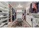 Well-organized walk-in closet with ample storage shelves, drawers, and a cozy rug at 11822 S Coconino St, Phoenix, AZ 85044