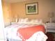 Bright bedroom features floral bedding, white nightstands, and a decorative painting above the bed at 12222 N Paradise Village S Pkwy # 325, Phoenix, AZ 85032