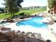 Community pool area with lounge chairs and well-manicured landscaping and golf course views at 12222 N Paradise Village S Pkwy # 325, Phoenix, AZ 85032
