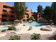 Inviting community pool with lush landscaping, rock features, and comfortable lounge areas at 12222 N Paradise Village S Pkwy # 325, Phoenix, AZ 85032
