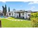Spacious backyard with a pool, lush lawn, and covered porch, ideal for outdoor living at 13207 N 55Th Ave, Glendale, AZ 85304